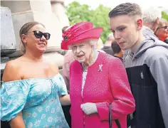  ?? ?? Wellwisher­s pose with a cardboard cut-out of the Queen outside St Paul’s in London before a service of thanksgivi­ng for her reign inside the cathedral yesterday