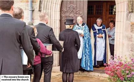  ?? ?? > The ossuary boxes are received into the church