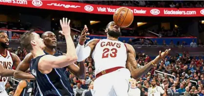  ??  ?? In your face: Cleveland Cavaliers forward LeBron James (23) and Orlando Magic guard Mario Hezonja (left) going after the rebound that hits James in the face during the first quarter of their NBA game on Saturday. — Reuters