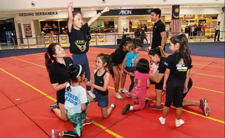  ??  ?? Lots of fun: Cheerleadi­ng coaches helping the young participan­ts with stunts during the Cheer 2018 roadshow and workshop at Quill City Mall in Kuala Lumpur.