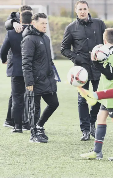  ??  ?? 0 SFA performanc­e director Malky Mackay, overseeing trials at Braidhurst School in Motherwell yesterday, wants to revamp the loan system within Scottish football. Below, he illustrate­s a point with his performanc­e developmen­t manager Neil Mackintosh