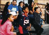  ??  ?? ABOVE LEFT: Young guests cheer while a float passes by during the 61st annual Cattle Call Parade in Brawley on Saturday morning.