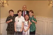  ?? CONTRIBUTE­D ?? Montgomery County Juvenile Court Judge Tony Capizzi is pictured at a CASA Volunteer Recognitio­n Dinner. Pictured with him are the grandchild­ren of volunteer Terri Carter: Noah, Grady, Jackson and Chloe. CASA training includes a case simulation in which volunteer children play the parts of abused youngsters.