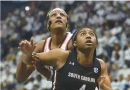  ?? CLOE POISSON/SPECIAL TO THE COURANT ?? South Carolina’s Aliyah Boston (4) and Uconn’s Aaliyah Edwards staged quite a battle Sunday, but Carolina prevailed 81-77.