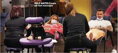  ?? ?? SOLE MATES Couple get foot massages