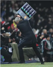  ?? Reuters ?? Jose Mourinho takes his frustratio­ns out on a tray of water bottles after Manchester United’s late winner