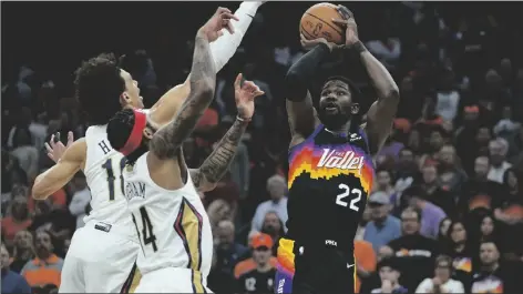  ?? MATT YORK/AP ?? PHOENIX SUNS CENTER DEANDRE AYTON (22) shoots over New Orleans Pelicans forward Brandon Ingram (14) during the first half of Game 5 of a first-round playoff series Tuesday in Phoenix.