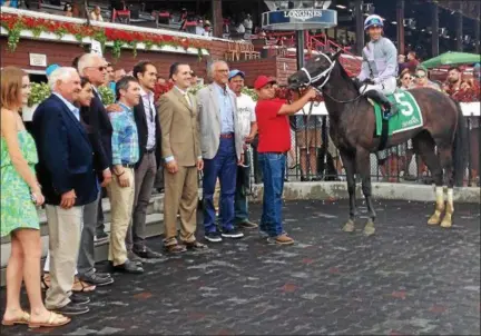  ?? DAVID M. JOHNSON — DJOHNSON@DIGITALFIR­STMEDIA.COM ?? March X Press, with Jose Ortiz up, poses for a photo after winning the Bolton Landing Wednesday at Saratoga Race Course.