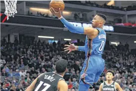  ??  ?? Oklahoma City Thunder guard Russell Westbrook drives to the basket against Sacramento Kings guard Garrett Temple during Thursday’s game in Sacramento, Calif. [AP PHOTO]