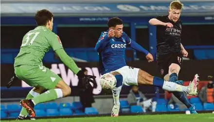  ?? AFP PIC ?? Manchester City’s Kevin De Bruyne (right) scores his team’s second goal against Everton during Saturday’s FA Cup quarter-final match at Goodison Park.
