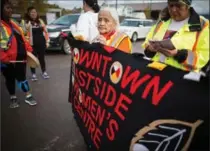  ?? DARRYL DYCK, THE CANADIAN PRESS ?? Mabel Todd, 83, of the Nak’azdli First Nation, helps carry a banner as Indigenous women and girls walk this week along the so-called Highway of Tears.