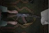  ?? FELIPE DANA — THE ASSOCIATED PRESS ?? A Taliban fighter lays his AK-47 rifle down during Friday prayers at a Mosque in Kabul, Afghanista­n.