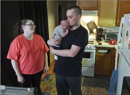  ?? BEN HASTY — MEDIANEWS GROUP ?? Heather Novak, Kevin Croak and their 2-month-old son, Jayden Croak, at their Boyertown apartment. Novak and Croak were behind on their rent due in part to the COVID-19pandemic and received help from Family Promise of Berks County that kept them from being evicted. The scenario is far too common in the pandemic, advocates say, but residents can get help.