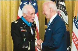  ?? SAUL LOEB/GETTY-AFP ?? President Joe Biden shakes hands Tuesday with retired Army Maj. John Duffy after presenting him with the Medal of Honor for his actions during the Vietnam War.