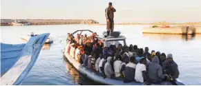  ?? - Reuters file photo ?? RESCUED: African migrants are seen seated in a boat, after being rescued by the Libyan navy near the coastal town of Gharaboli, east of Tripoli, Libya, on November 20, 2014.