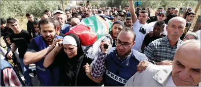  ?? Photo: Nampa/Xinhua ?? Killed… People carry the body of Al-Jazeera journalist Shireen Abu Akleh during her funeral in the West Bank city of Jenin on 11 May 2022.