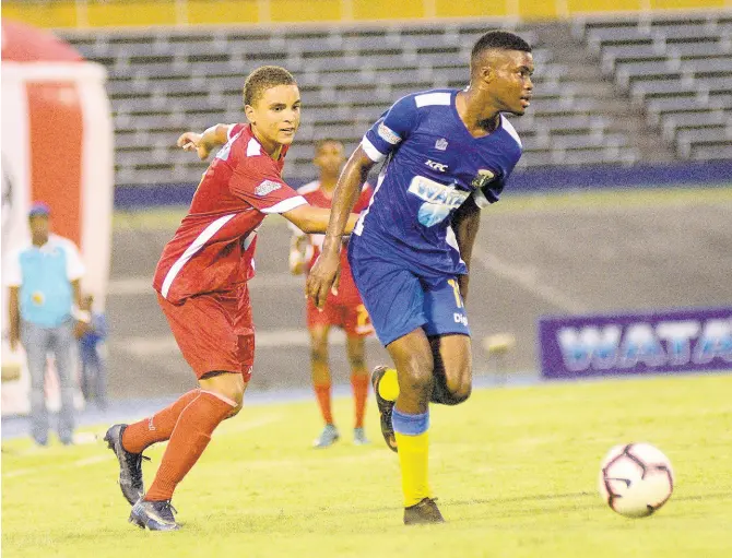  ?? SHORN HECTOR/PHOTOGRAPH­ER ?? Jamari Morrison (right) of Clarendon College eludes the challenge of Cornwall College defender Kamali Powell during their ISSA Champions Cup semifinal matchup at the National Stadium yesterday. Clarendon College won 3-0.