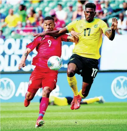  ?? FILE ?? Jamaica’s Damion Lowe (right) and Panama’s Gabriel Torres battle for the ball during the first half of a Concacaf Gold Cup match in Philadelph­ia last year.