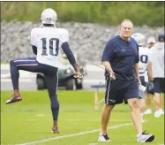  ?? Steven Senne / Associated Press ?? The Patriots’ Josh Gordon warms up as coach Bill Belichick walks on the field during practice Wednesday.