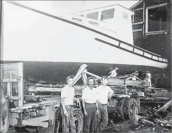  ?? CONTRIBUTE­D ?? The first boat built by Roland DesChamp Sr. (left) and William Buck Jackson (right) was built for Lloyd Bower.