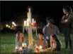  ??  ?? Rich and Rachel Castleberr­y visit one of seventeen crosses after a candleligh­t vigil for the victims of the Wednesday shooting at Marjory Stoneman Douglas High School, in Parkland, Fla., Thursday, Feb. 15, 2018. Nikolas Cruz, a former student, was...