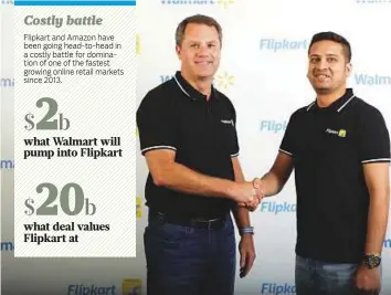  ?? AFP ?? Walmart CEO Doug McMillon (left) and Flipkart co-founder and CEO Binny Bansal shaking hands at an event in Bengaluru following the announceme­nt of the deal.