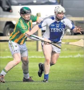  ??  ?? Ringtown's Paul Smith tries to halt the progress of St Pat's Andy O'Brien during the Leinster hurling league semi-final. Picture: Garry O'Neill