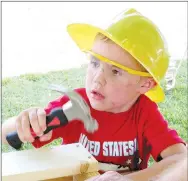  ?? Westside Eagle Observer/RANDY MOLL ?? Teancum Hubler, 4, pounds in nails on a toolbox he was finishing in the Meeks Lumber booth at the Gentry Freedom Festival on Thursday.