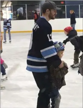  ?? ANDREW CASS — THE NEWS-HERALD ?? Members of the Mentor Ice Breakers hockey team joined the Richmond Heights and Euclid police department­s Feb. 2 for the Skating with a Cop event.