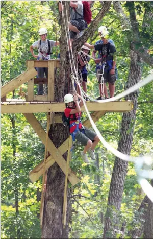  ?? Arkansas Democrat-Gazette/RICK McFARLAND ?? Amber Simmons, of Orange Grove, Texas, takes off from a platform on one of nearly a dozen zip lines in the Buffalo River Canopy Tour in 2010.