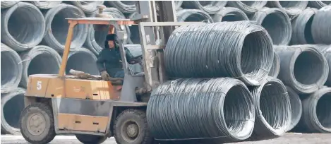  ??  ?? An employee transports steel products at a steel market in Shenyang in China’s northeaste­rn Liaoning province.