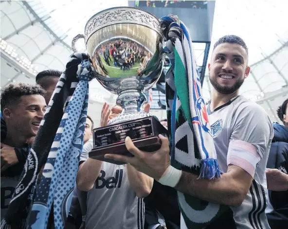  ?? — THE CANADIAN PRESS ?? Whitecaps captain Pedro Morales hoists the Cascadia Cup after Vancouver beat the Portland Timbers 4-1. The trophy was created by fans of the Whitecaps, Timbers and Seattle Sounders and is awarded each season to the best team in the Pacific Northwest.