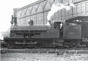  ?? ARPT Collection ?? With the south-facing glass façade of Carlisle’s Citadel station as a backdrop, this pre-1920 view records NER ‘BTP’ 0-4-4T No 950 and its crew during a quiet spell between duties. The Fletcher-designed ‘Bogie Passenger Tanks’ had many variations, this example being a May 1874-product of Neilson & Co Ltd (Works No 1832) built with 5ft 0¼in driving wheels, 3ft trailing wheels and cylinders of 16in bore and 22in stroke. Note that the splashers are ‘closed’, the sandboxes integral, and the cab has round spectacle plates. Unlike many of its classmates, NER No 950 was only rebuilt once, in June 1888, the change including a Worsdell boiler, cylinders bored to 17in, and its stovepipe chimney has been replaced. Clearly a local engine given its 1,000 gallon water capacity, the transfer date of No 950 away from Carlisle is unknown but at the end of
1920 it was on the allocation of South Blyth shed. Long-lived by the grouping, No 950 was withdrawn in February 1923.