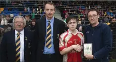  ??  ?? Martin Coleman, Martin Fitzgerald and Brendan Lawrence present the Wicklow People sponsored Man of the Match award on the losing side to Luke O’Tooles Gearoid Donohue.