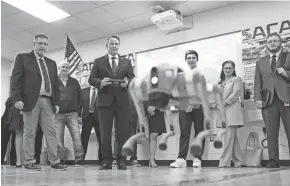  ?? ?? Jason Hoffman of Buckeye Educationa­l Systems, left, watches as Lt. Gov. Jon Husted controls a quadruped robotic dog during the grand opening of the Johnstown-monroe School District’s newest Innovation Center.