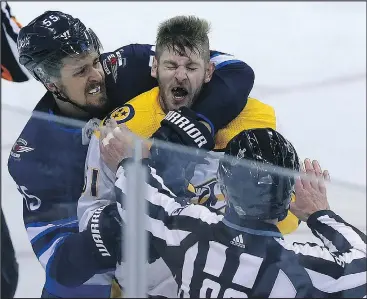  ?? KEVIN KING ?? The Jets’ Mark Scheifele grabs the Predators’ Austin Watson after he hit Blake Wheeler during Game 3 of their second-round series in Winnipeg on Tuesday night.