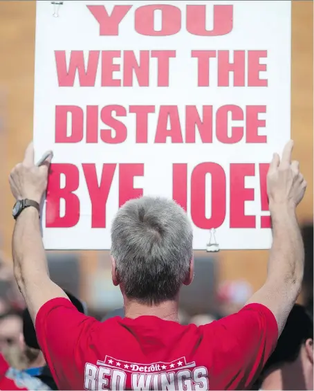  ?? DAX MELMER ?? Hank Stawasz of Livonia, Mich., holds up a sign showing his support before the final Detroit Red Wings hockey game at Joe Louis Arena on Sunday. “We now know how the people at Olympia felt when the Olympia closed,” fan Kay Redmond said.