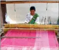  ?? ANI ?? A tribal lady weaves a Dokhona Bodo traditiona­l dress for women, at Moinaguri village, in Kokrajhar in Assam on 17 November.