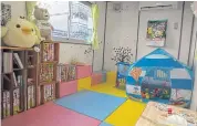  ??  ?? A waiting room is available for employees’ children at a Takenaka Corporatio­n constructi­on site in Tokyo.