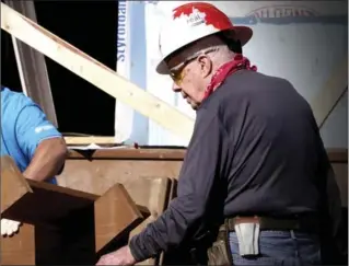  ?? STACIA FRANZ, MANITOBA GOVERNMENT, THE ASSOCIATED PRESS ?? Former U.S. president Jimmy Carter is seen Thursday building stairs at a Habitat for Humanity home in Winnipeg.