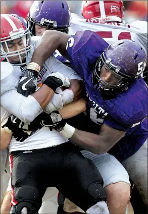  ?? Arkansas Democrat-Gazette/THOMAS METTHE ?? Defensive lineman Dameyun McDonald (right) helps lead a Ouachita Baptist defense that leads NCAA Division II with 9.4 points allowed per game heading into Saturday’s quarterfin­al playoff game against Ferris State.