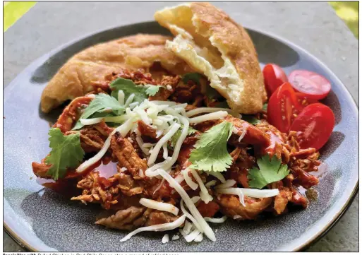  ??  ?? Sopaipilla­s with Pulled Chicken in Red Chile Sauce atop a mound of refried beans