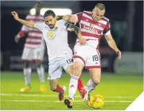  ??  ?? Thistle’s Ryan Edwards tackles Darian Mackinnon.