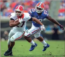  ?? KEN WARD / For the Calhoun Times ?? Georgia’s Nick Chubb (27) tries to break away from Florida’s Chauncey Gardner, Jr. during last Saturday’s game.