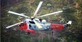  ??  ?? Urgent: A Gannet Sea King flies low and fast through Glen Coe