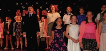 ??  ?? On Song Matthew Semple as Daddy Warbucks and some of the cast