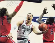  ?? David Butler / Associated Press ?? UConn guard Tyrese Martin shoots against St. John’s forward Josh Roberts (1) and guard Dylan Addae-Wusu (5) in the first half in January.