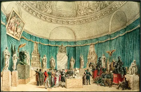  ??  ?? Trophées. Gravure de Charles Normand et Benjamin Zix représenta­nt la « salle de la victoire » du musée Napoléon – celui-ci a fait rebaptiser le Louvre – en 1807. À la chute de l’Empire, environ 5 000 oeuvres d’art repartiron­t pour leur pays d’origine.