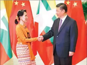  ?? DAMIR SAGOLJ/AFP ?? Myanmar State Counsellor Aung San Suu Kyi (left) shakes hands with Chinese President Xi Jinping at the Great Hall of the People in Beijing on May 16.