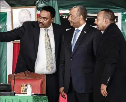  ?? TONY KARUMBA / AFP ?? Chairman of Sudan’s Transition­al Sovereign Council Abdel Fattah Al-Burhan (center) and Ethiopian Prime Minister Abiy Ahmed (right) attend the 39th IGAD extraordin­ary summit in Nairobi on July 5.